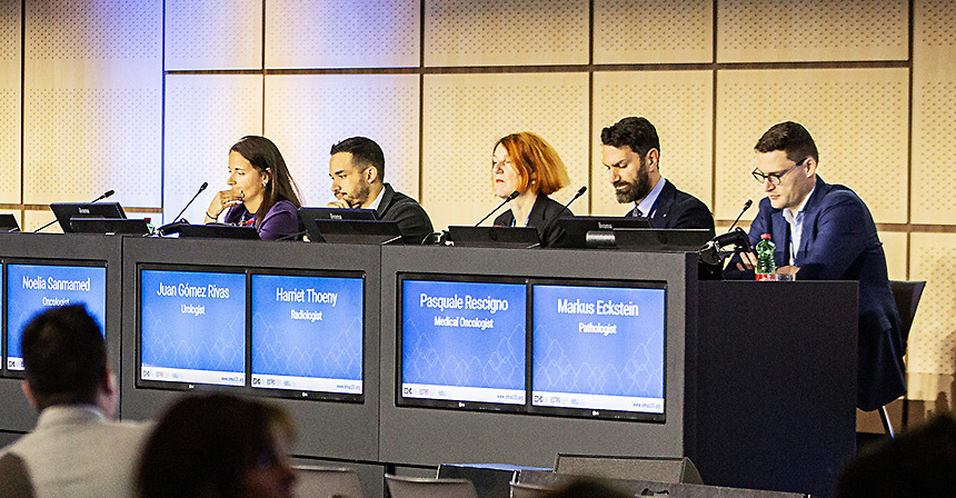 5 panelists behind a desk